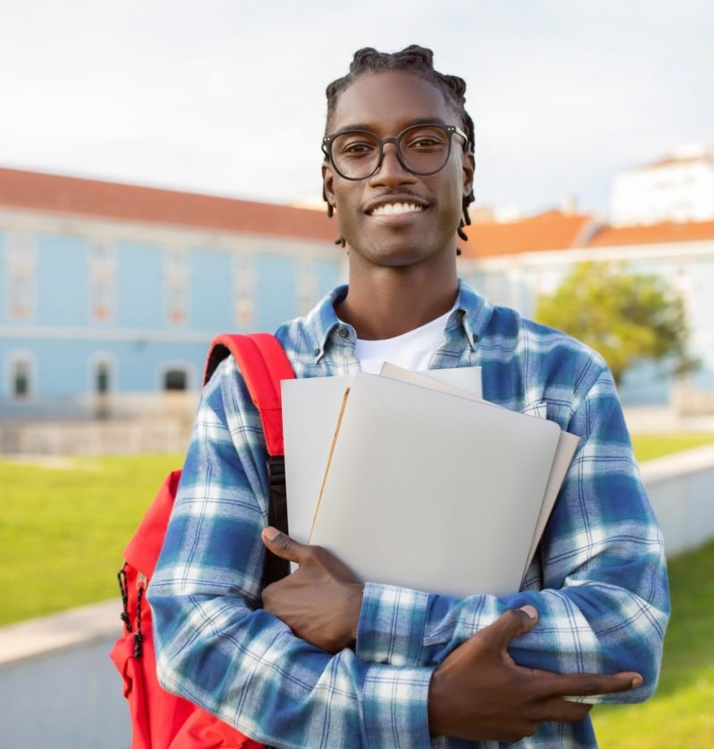 black-student-guy-stands-with-laptop-backpack-and-2026-01-08-23-03-51-utc (1) (1)