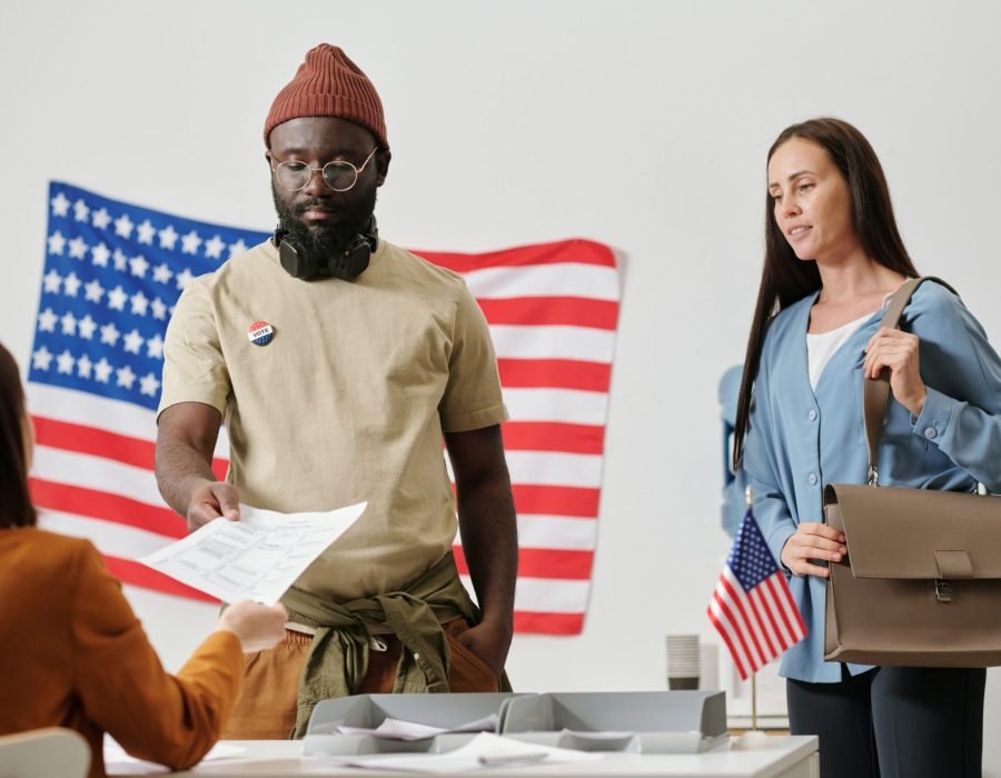 young-black-man-taking-ballot-paper-by-desk-of-ele-2026-01-08-22-24-08-utc (1) (1)